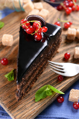 Tasty chocolate cake with berries on table close up