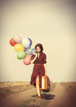 girl with multicolored balloons and bag