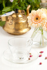 Bunch of gerbera flower with empty glass cup
