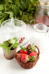 Basket of fresh strawberries and milk