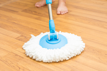 Cleaning wood floor by modern mop.