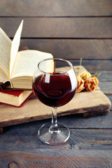 Beautiful composition with glass of wine with old books on table close up