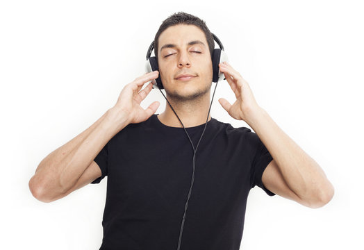 Young man listening music on white