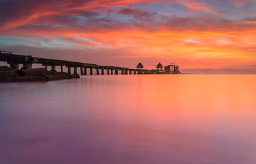 Fototapeta na wymiar Wooded bridge in the port and sunset