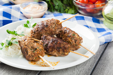 Barbecued kofta with rice on a plate