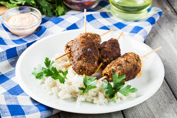 Barbecued kofta with rice on a plate