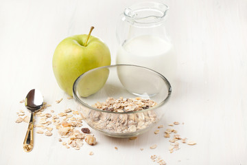 Breakfast with muesli, milk and apple