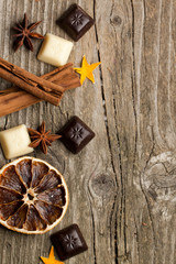 Background with cinnamon, anise, orange and chocolate