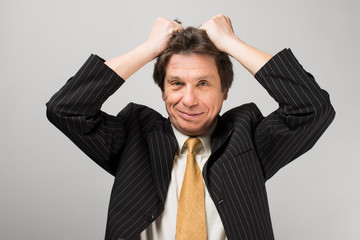 man holding his hands on his head stress