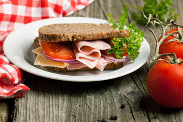Fresh sandwich with ham and tomato