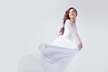 Fototapeta na wymiar Beautiful bride in wedding dress, white background