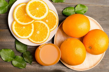Navel orange fruit and juice on wooden background