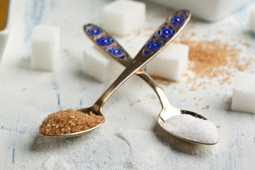Tow spoons with sugar