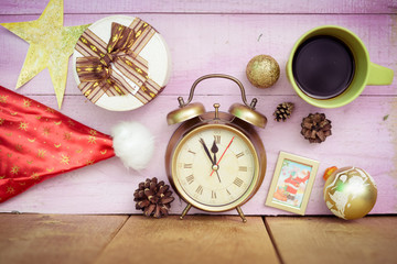 Closeup of coffee cup, alarm clock and christmas decorations on