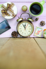 Picture of coffee cup, alarm clock and christmas decorations on