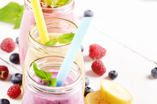 Assorted fruit shakes on white table