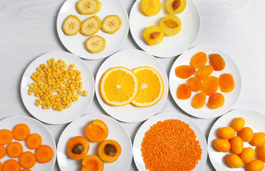 Set of orange products on wooden table, closeup