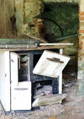 rusty wood-burning stove in an old abandoned house