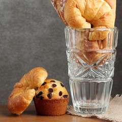 croissant brad muffin  bakery in glass blow on teakwood table