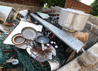old pans and washing machine basket and rusty iron ore