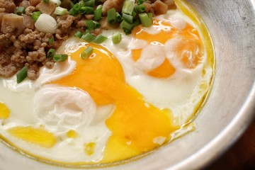 Breakfast with fried eggs on pan