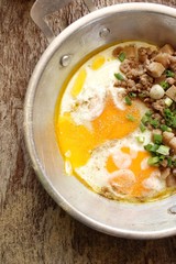 Breakfast with fried eggs on pan