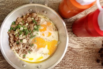 Breakfast with fried eggs on pan