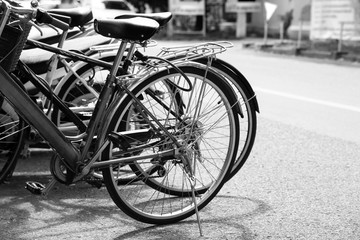 Fototapeta na wymiar Vintage bicycle on urban roadside. black and white effect