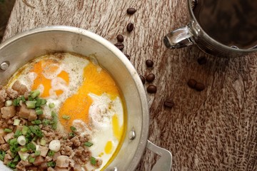 Breakfast with  fried eggs on pan and hot coffee
