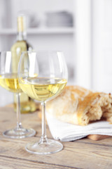 Still life of wine and bread on light background