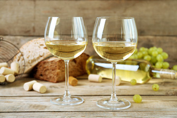 Still life of wine and bread on rustic wooden background