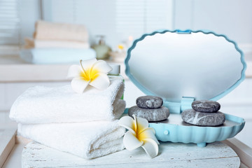 Spa stones and spa treatments on light background