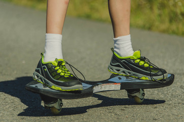 Fototapeta premium Legs in sneakers on a skateboard