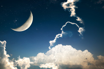 A fantasy of night sky cloudscape with stars and a crescent moon overlaid, vintage color toned