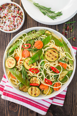 Spaghetti and grilled vegetables - zucchini, carrots, pea pods a