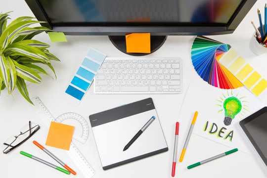 Graphic designer at work. Color samples.