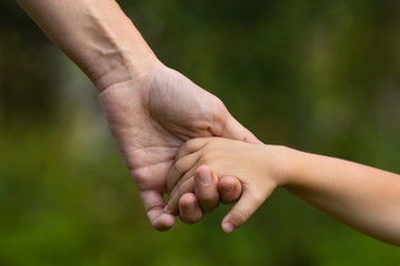 mother holding a child's hand