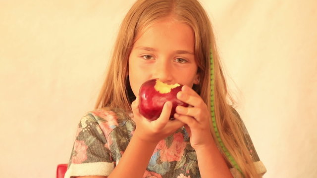 Cute girl eating apple