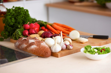 Grocery shopping bag with vegetables on kitchen