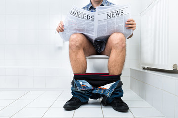 Man In Toilet Reading Newspaper