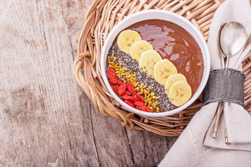 Chocolate banana pudding garnished with bee pollen, goji berries, chia seeds