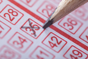 Person Marking Number On Lottery Ticket