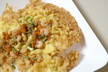 crispy omelet with shrimp and vegetable on top