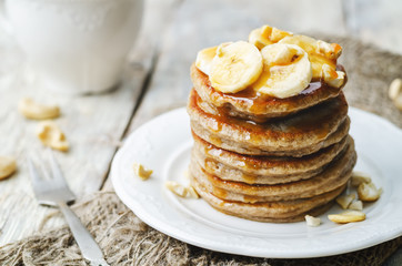 banana cashew pancakes with bananas and salted caramel sauce