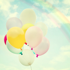 vintage colorful balloon with rainbow on blue sky concept of love in summer and valentine, wedding honeymoon