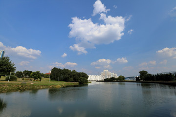 Residential white apartment house on the banks of the narrow river
