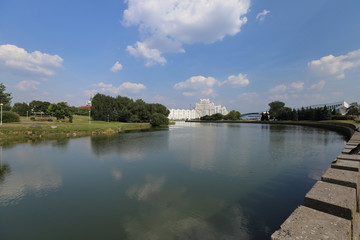 Fototapeta premium Residential white apartment house on the banks of the narrow river
