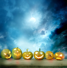 Spooky halloween pumpkins on a wooden table