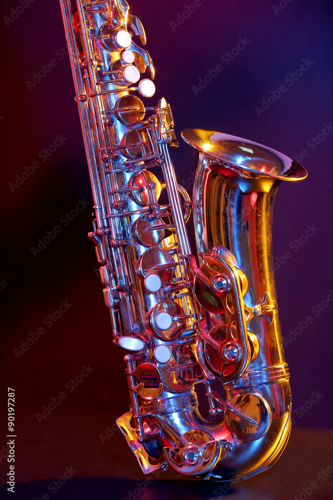 Wall mural Golden saxophone on purple background