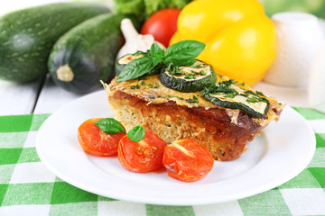 Casserole with vegetable mallow in white plate on table, closeup
